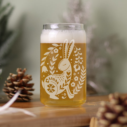 16 oz can glass filled with beer with Scandinavian design featuring rabbit and florals