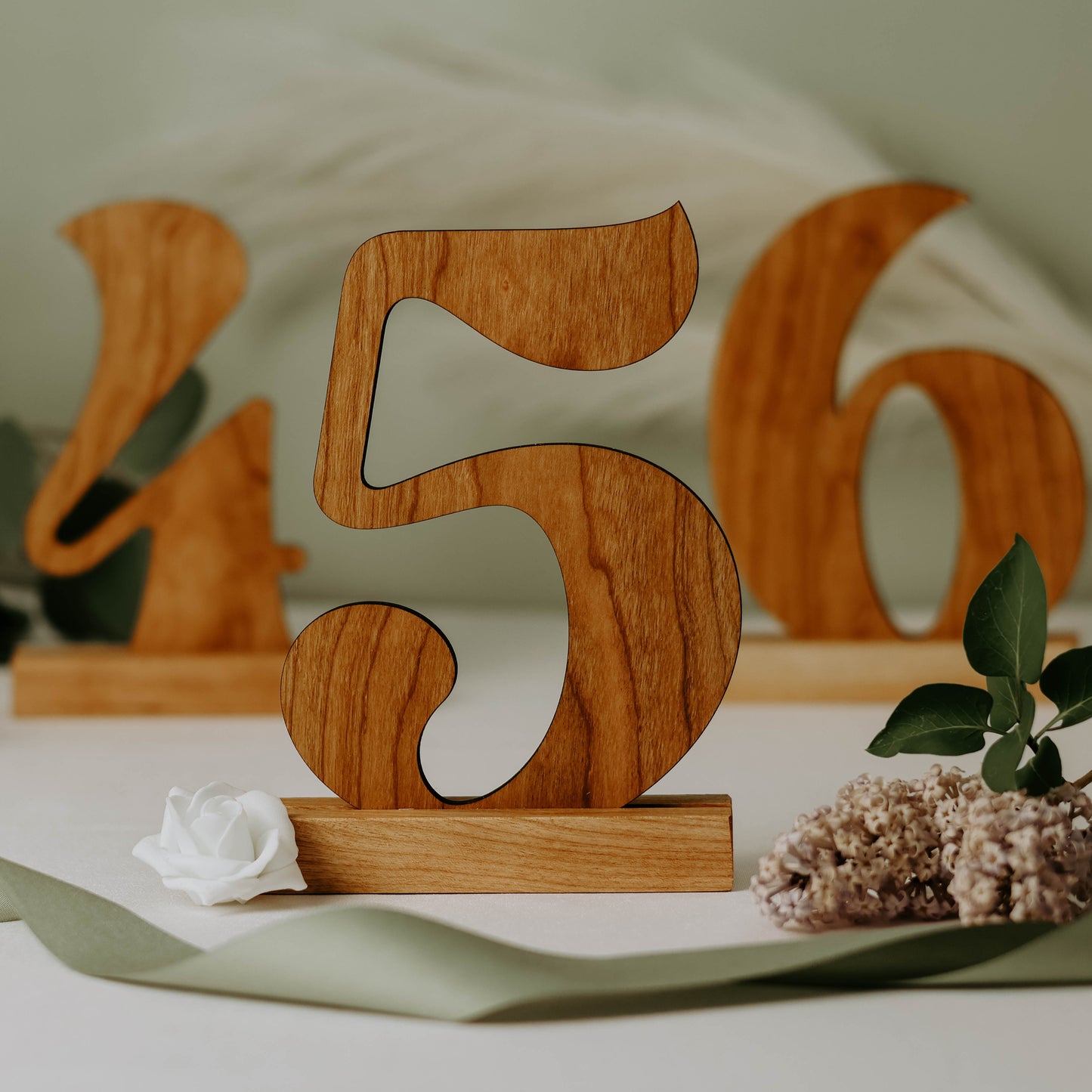 Image of cherry wood cutout table numbers 4,5,and 6.