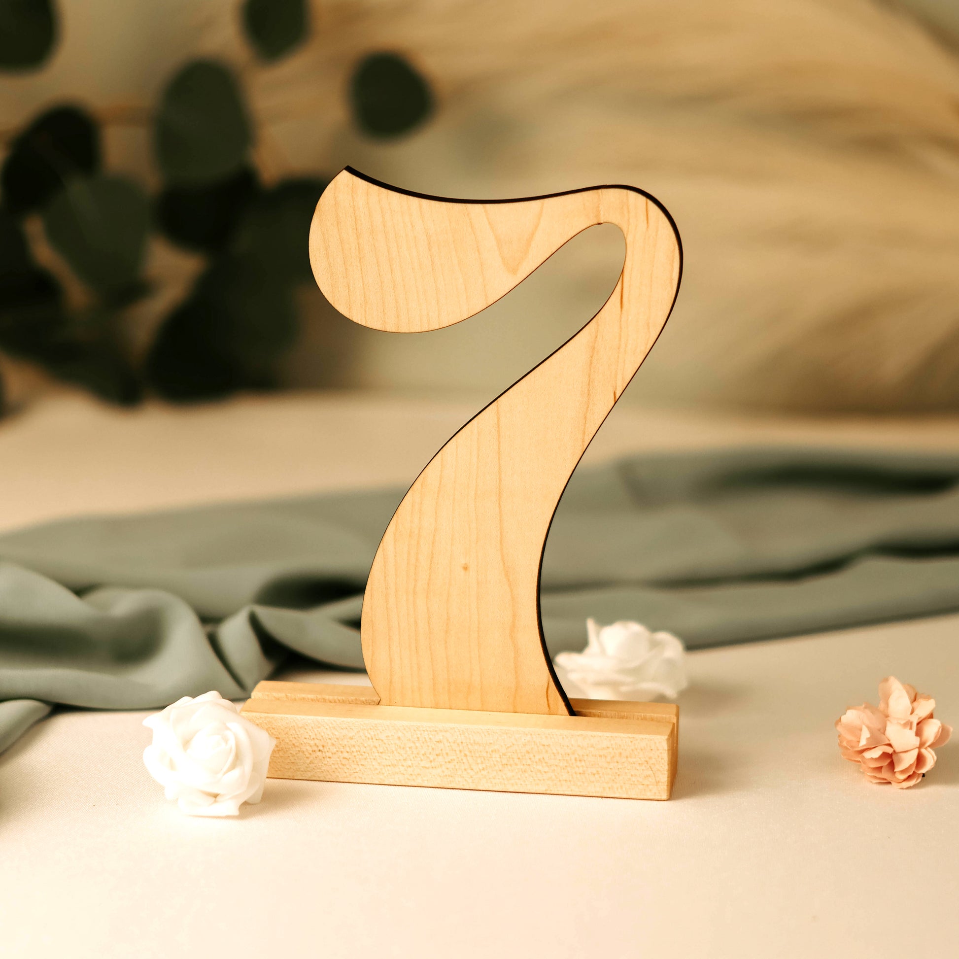 Photo displaying maple wood wedding table number '7' cutout