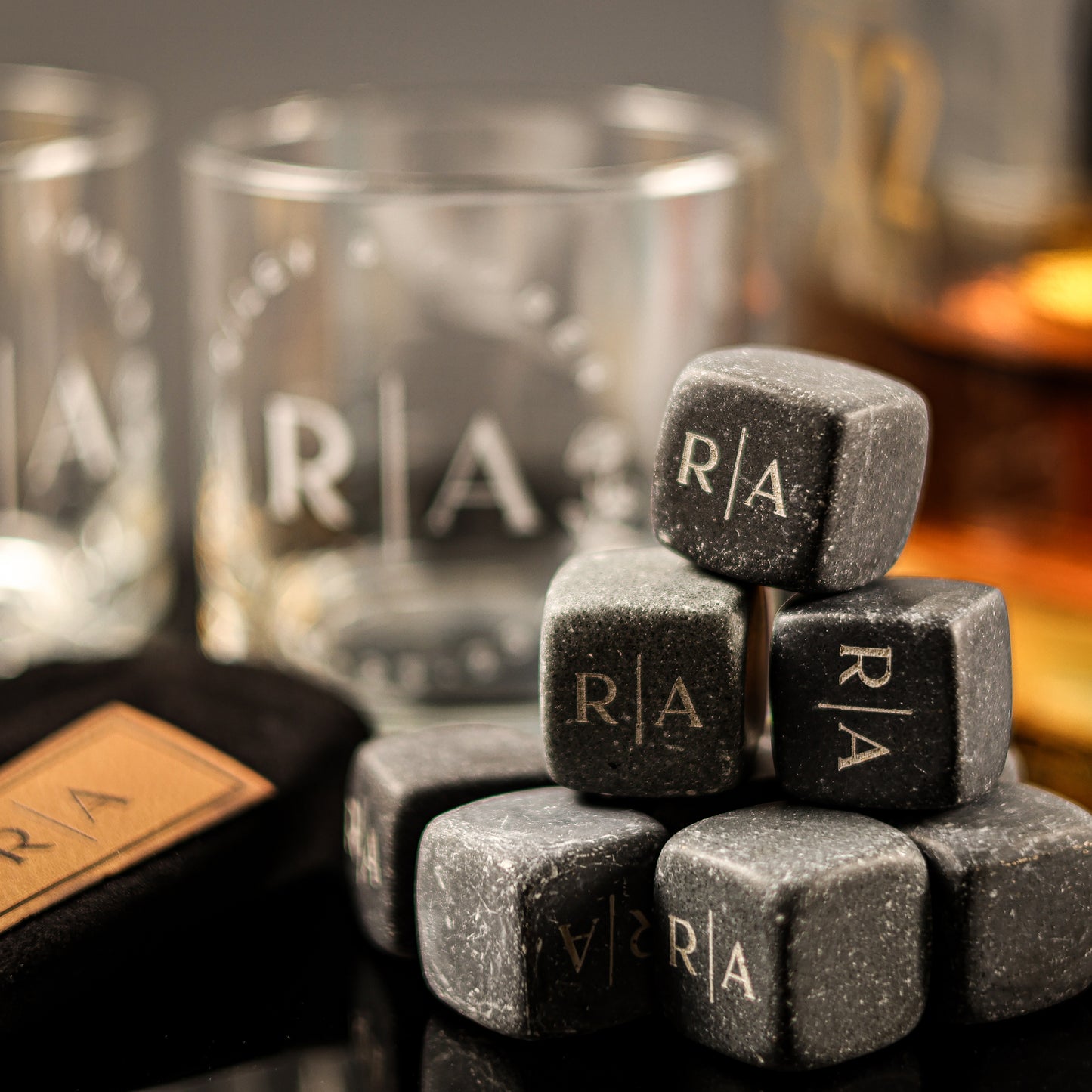 A set of whiskey stones and rocks glasses with engraved names, initials, and wedding date.