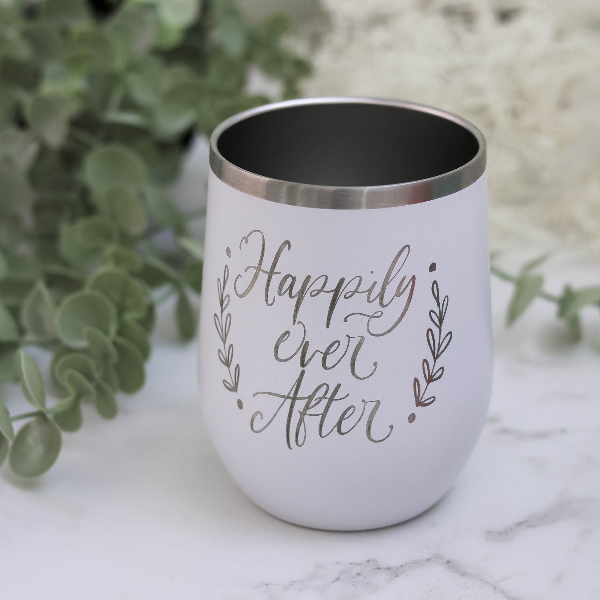 Stain less steel insulated wine tumbler engraved with the words "Happily Ever After" in white color.