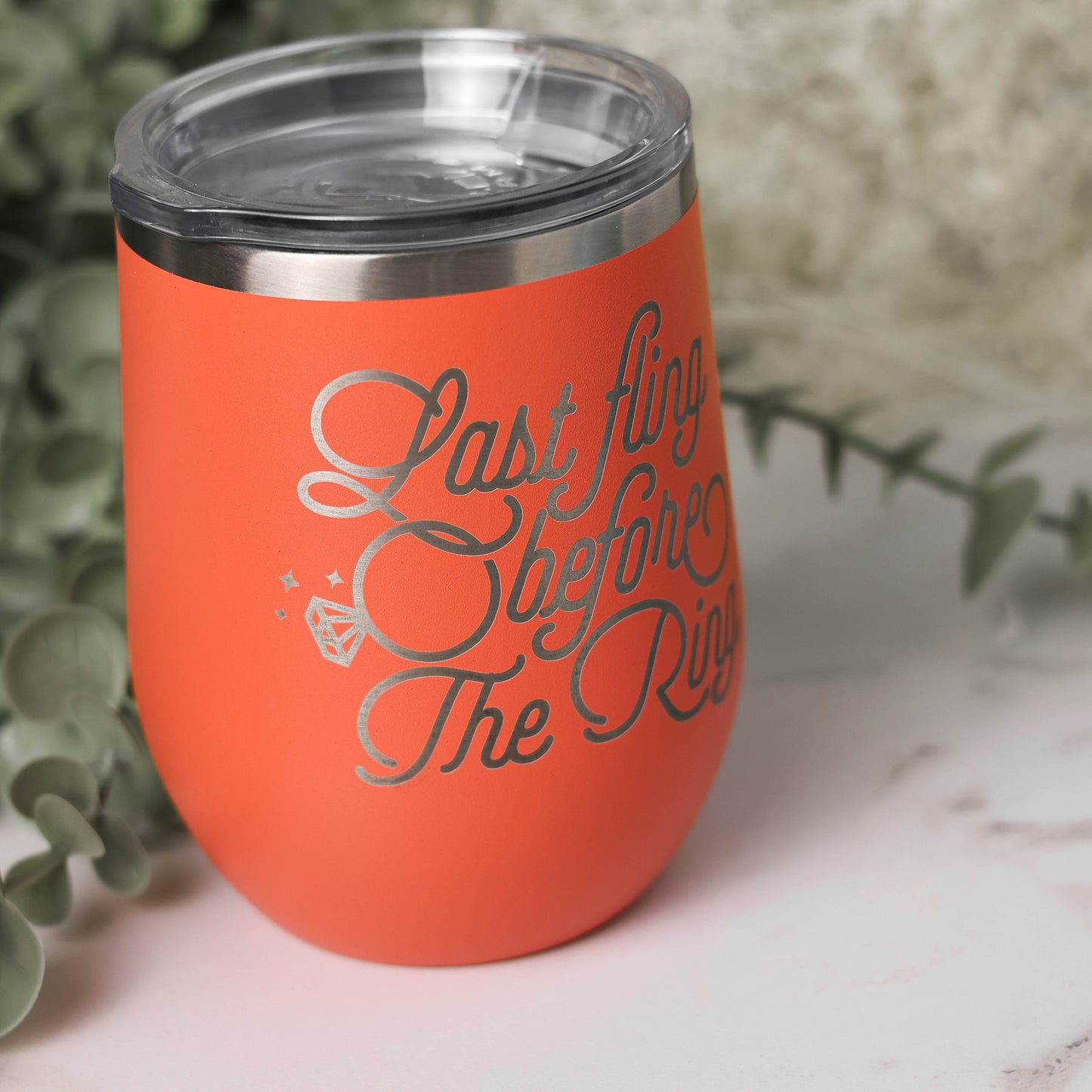 Stain less steel insulated wine tumbler engraved with the words "Last Fling before the Ring" in coral color.